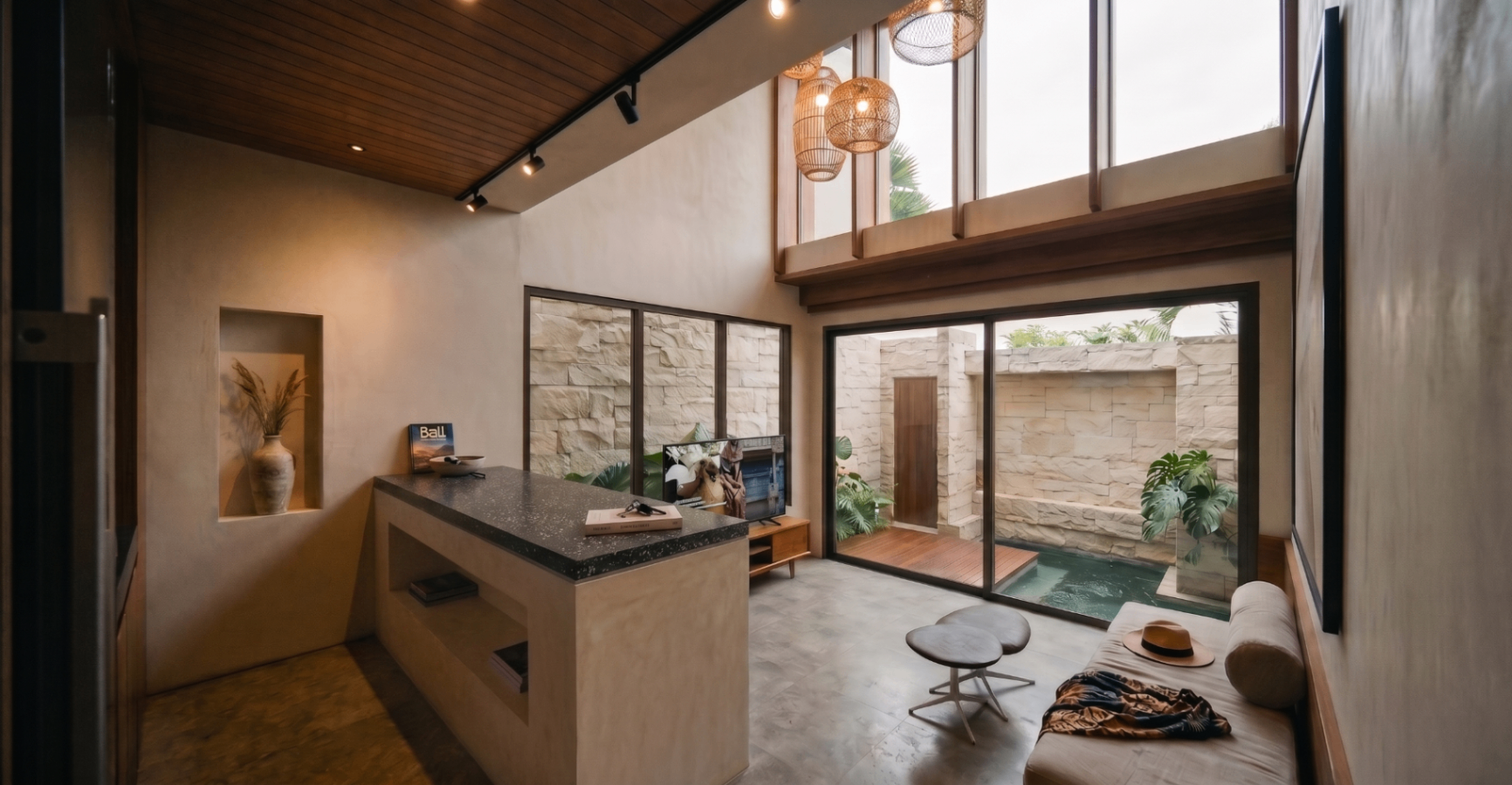 Open living room with mezzanine and pool view